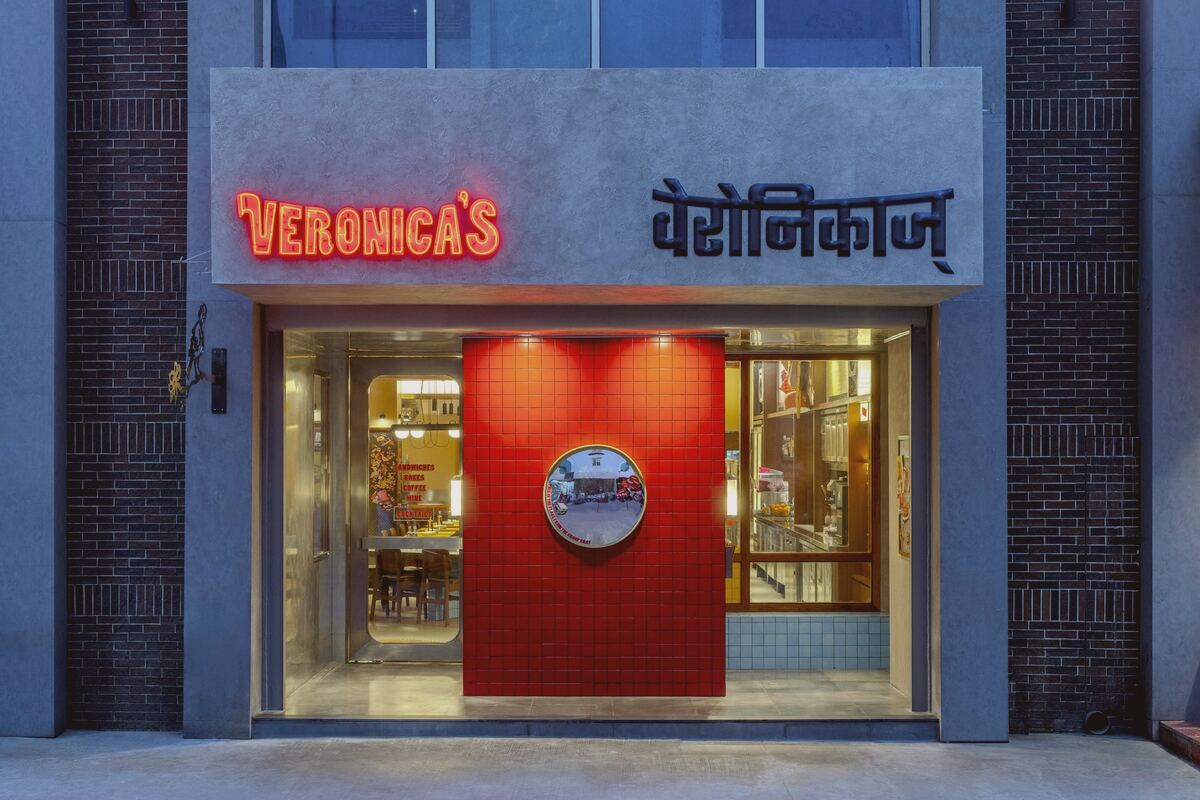 The Veronica's storefront on Waroda Road, Bandra West, its name lit in English and Devanagari above a red doorway